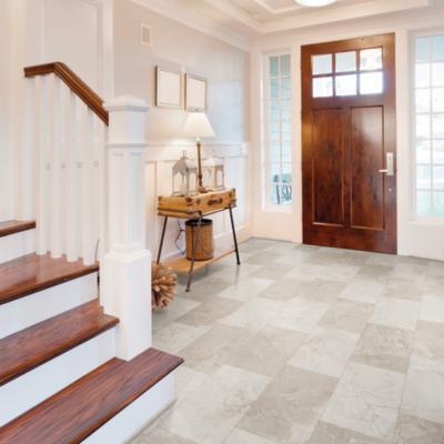 luxury vinyl tile flooring in entryway with stairs and entryway table.